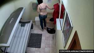 Busty MILF rubbing her pussy in Solarium