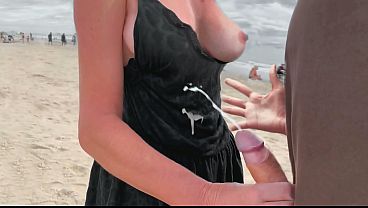 A milf jerk off a stranger on a public beach for a bet!